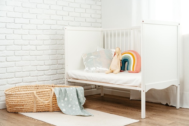 Kids room interior with comfortable bed and rainbow pillow