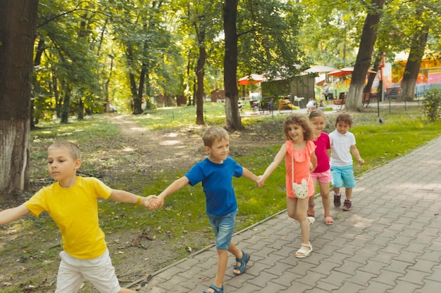 Kids standing in line holding hands with each other