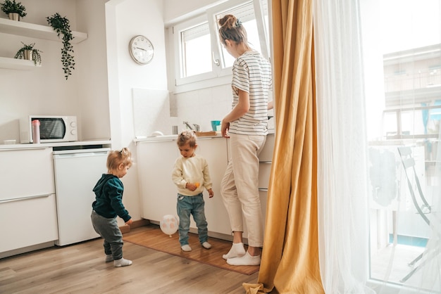 Kids and their mother in the kitchen