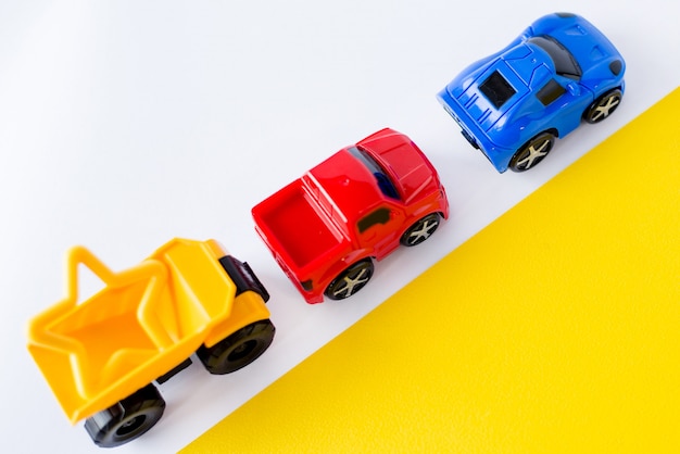 Kids toys cars on white and yellow. 