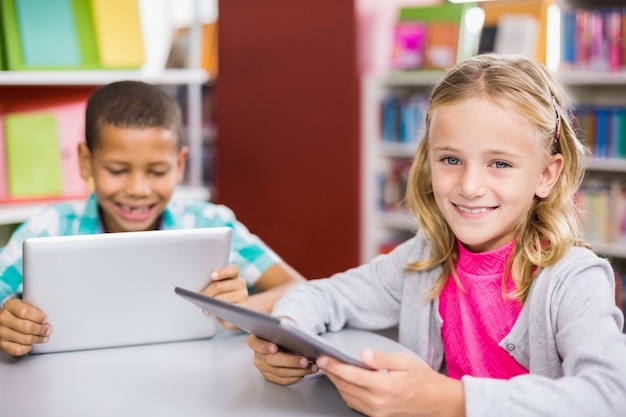 Kids using digital tablet in library