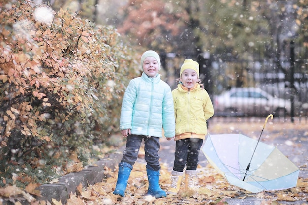 Kids walk in the park first snow