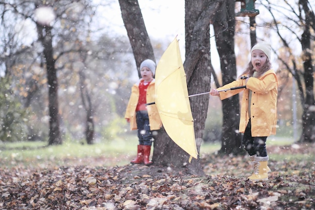 Kids walk in the park first snow