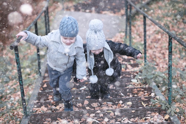 Kids walk in the park first snow