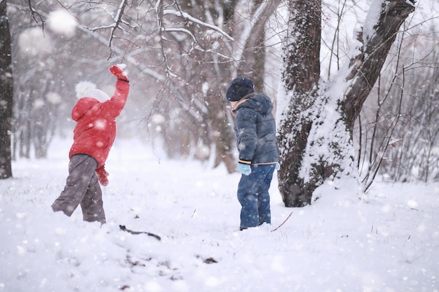 Kids walk in the park first snow