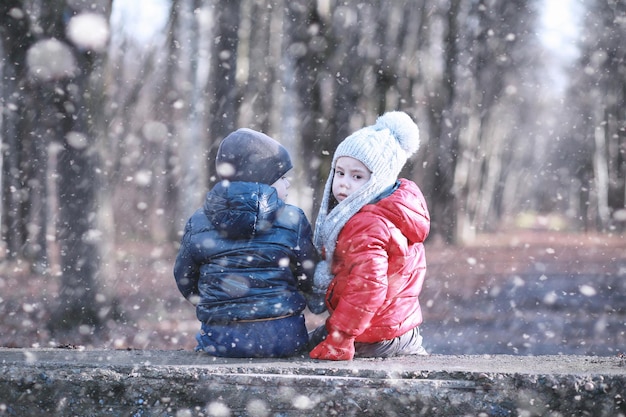 Kids walk in the park first snow