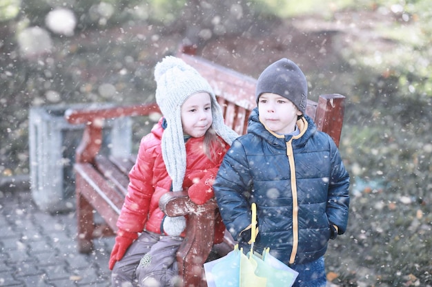 Kids walk in the park first snow