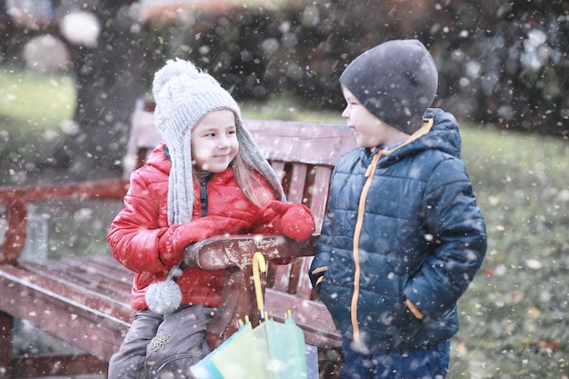 Kids walk in the park with first snow