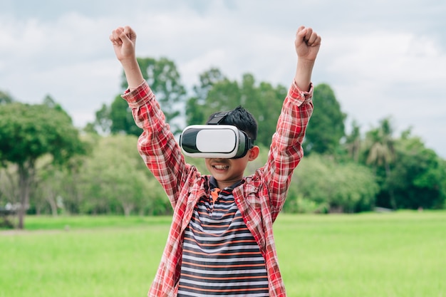 Kids wearing virtual reality video glasses and joyful in beautiful nature background