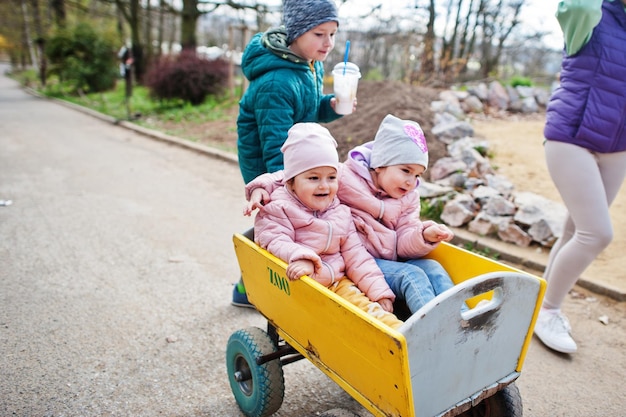 Kids at wooden trolley at the zoo