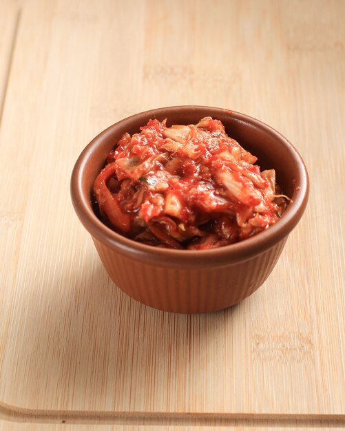 Kimchi, Korean Traditional Fermented Appetizer Cabbage Kimchi Pickle Salad in Brown Ceramic Bowl with Over Wooden Background