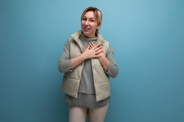 Kind blond millennial woman on blue isolated background