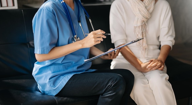 Kind nurse together with elderly woman in the hospital's