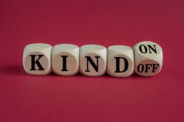 Photo kind on or off symbol turned wooden cubes and changes word kind off to kind on