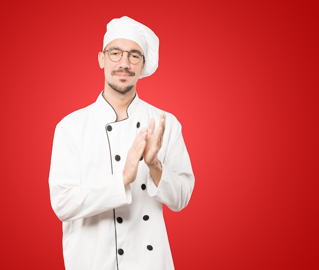 Kind young chef applauding gesture