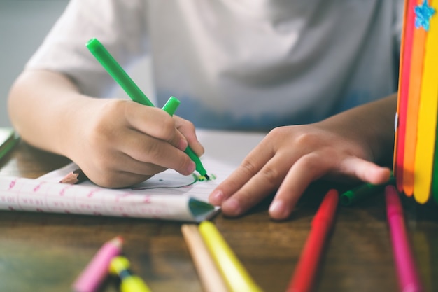 Kindergarten boy drawing and learning at home. Education, distance learning concept.