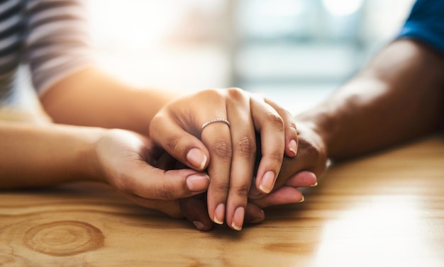 Kindness can change someones entire day Cropped shot of an unidentifiable man and woman holding hands on a table