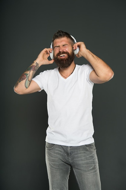 King of sound play it loud Bearded man listen to sound track Hipster enjoy sound of music playing in earphones Music and technology Fun and entertainment Mot all music sound the same