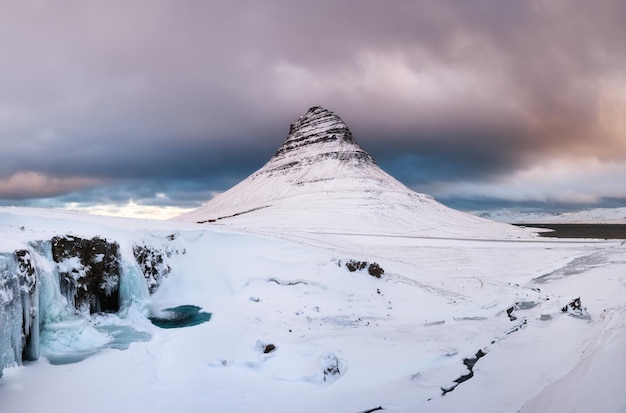 Kirkjufell mountain Iceland Kirkjufellsfoss waterfall Winter landscape Snow and ice A popular place to travel in Iceland