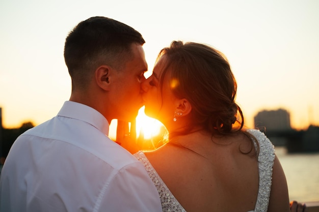 A kiss of the bride and groom at sunset Wedding article A happy couple Love Photos for printed products