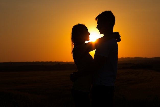 kissing romantic portrait enjoying sunset