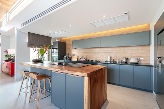 kitchen area which feature island counter and built in furniture