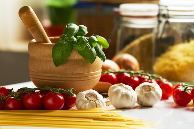 Kitchen Background Cooking Food Concept. Closeup of Cooking Process. Vegetables on Table. Cooking of Italian Pasta.