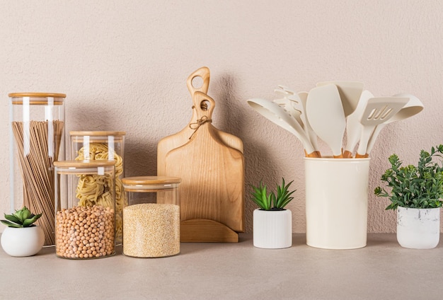 Kitchen background A set of kitchen utensils and various utensils for cooking on a stone kitchen countertop Front view Ecofriendly cuisine