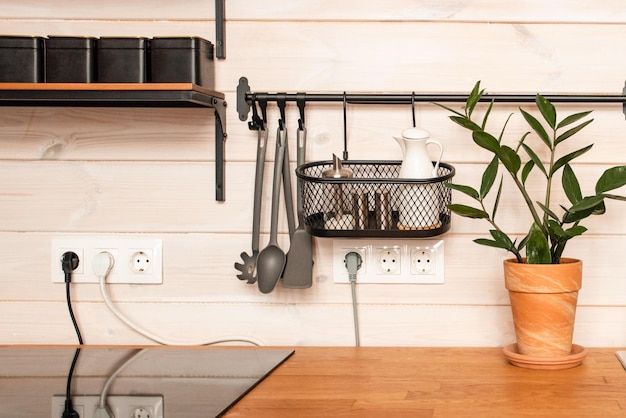 Kitchen brass utensils chef accessories hanging kitchen with white tiles wall and wood tabletopkitch