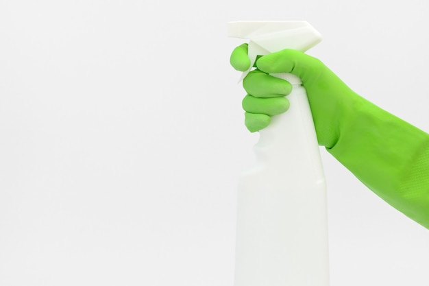 Kitchen cleaner in hand, hand with a green glove