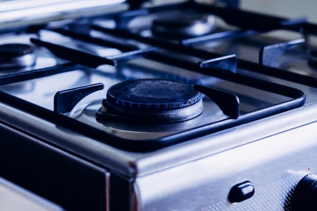 Kitchen gas hob stove cook with blue flames burning