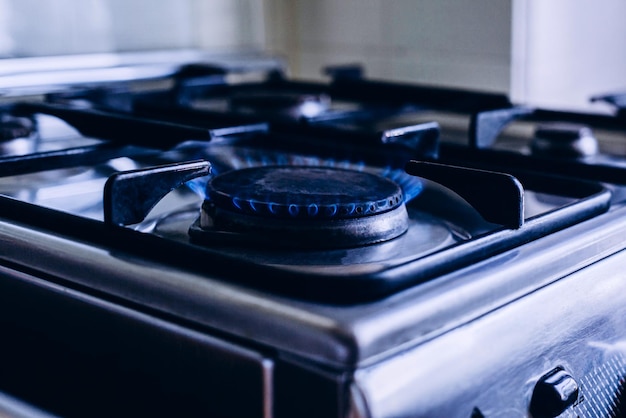 Kitchen gas hob stove cook with blue flames burning