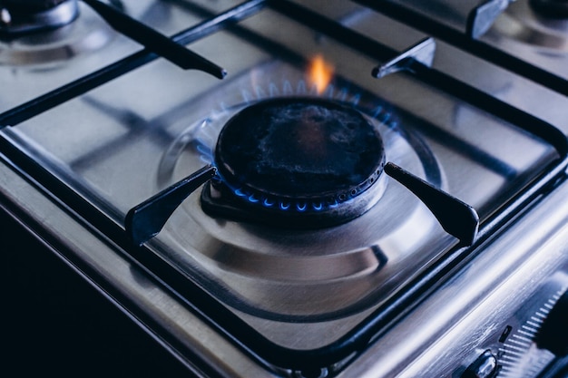 Kitchen gas hob stove cook with blue and orange flames burning