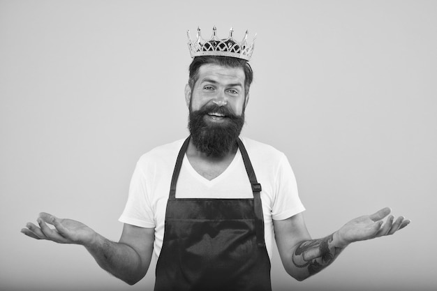 Kitchen is my kingdom Cook with beard and mustache yellow background Royal recipe Man king cook wear cooking apron and golden crown Ideas and tips Chief cook and professional culinary Cook food