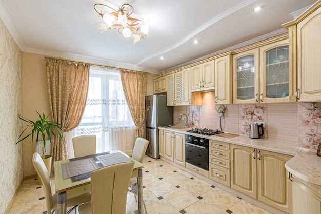 Kitchen in a modern style with a large table in light colors