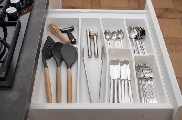 kitchen opened drawer with utensils and cutlery set Order in kitchen Kitchen modern interior