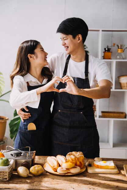 In Kitchen Perfectly Happy Couple Preparing Healthy Food Lots of Vegetables Man Juggles with Fruits Makes Her Girlfriend Laugh Lovely People in Love Have Fun