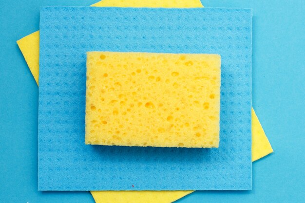 Kitchen rags and sponges on a blue background. flat lay.