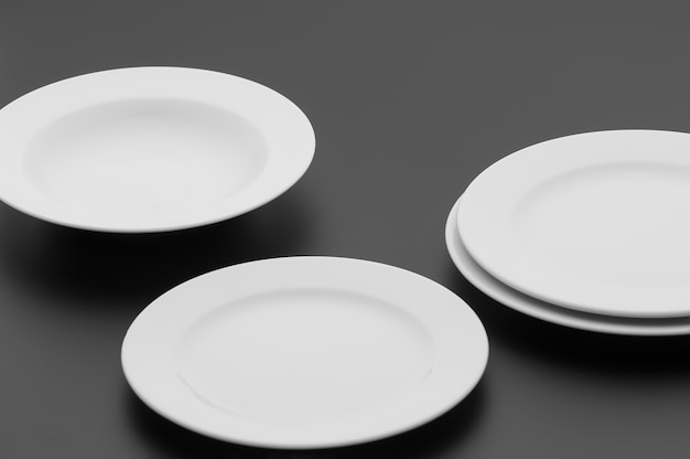 Kitchen and restaurant utensils, plates, on a dark background