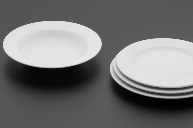 Kitchen and restaurant utensils, plates, on a dark background