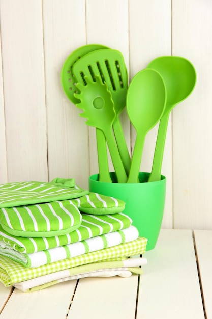 Kitchen settings utensil potholders towels and else on wooden table