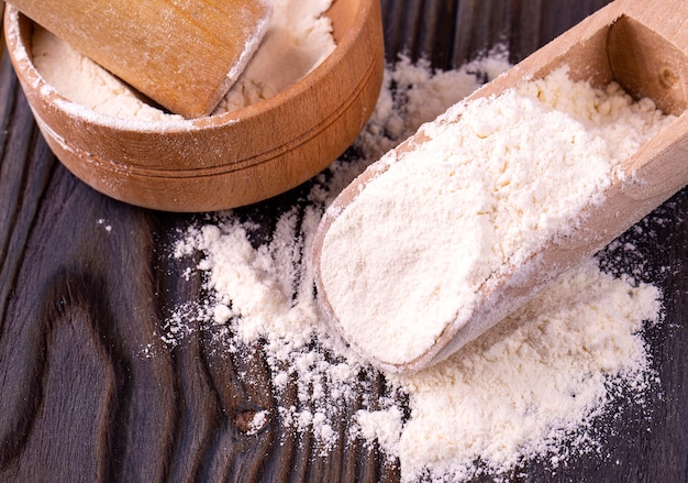 Kitchen still life with flour on the wooden table. Closeup.