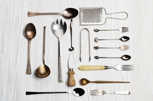 Kitchen utensils background - spoons, forks, cheese knife, grater, tongs