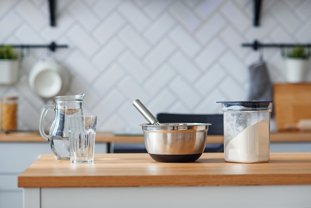 Kitchen utensils for homemade baking on a light wooden kitchen table