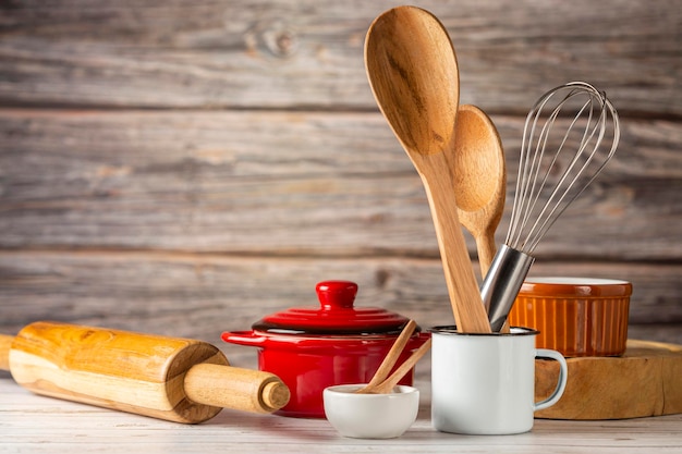 Kitchen utensils on wooden background