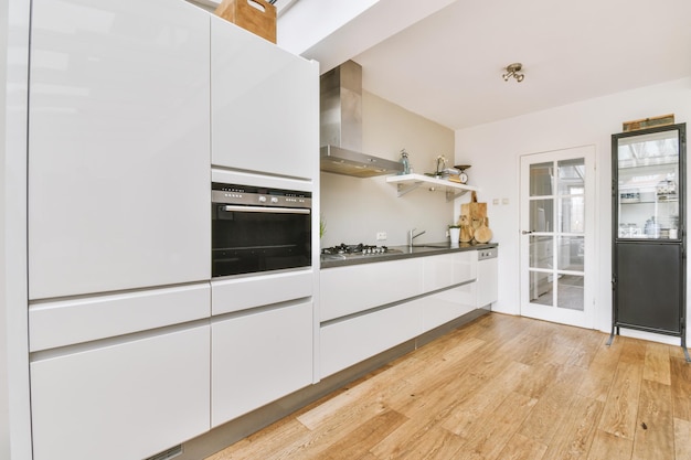 Kitchen with contemporary white furniture and appliances