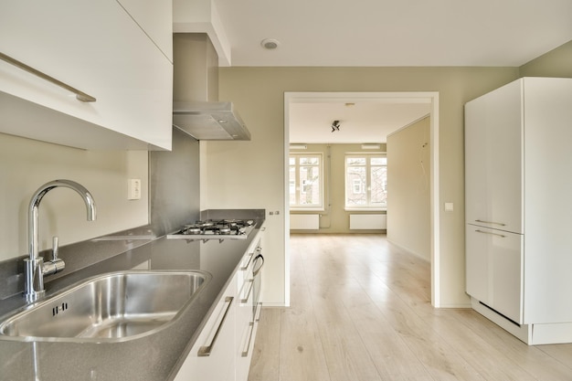 A kitchen with stainless steel counter tops and a sink