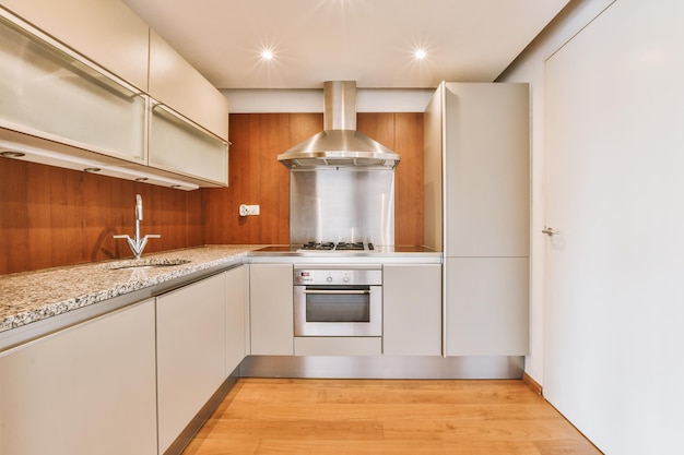 A kitchen with white cabinets and a counter top