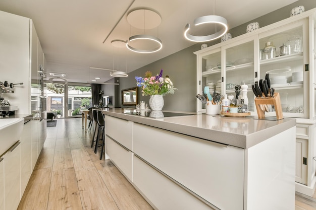 A kitchen with white cabinets and a long counter top