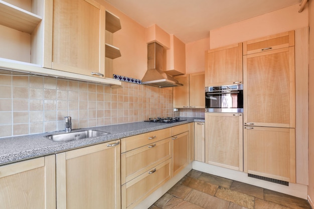 A kitchen with wooden cabinets and a sink